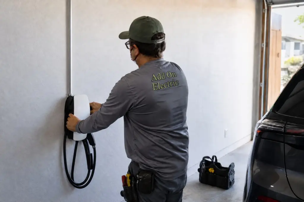 Electrician installing a Level 2 EV charger in a garage