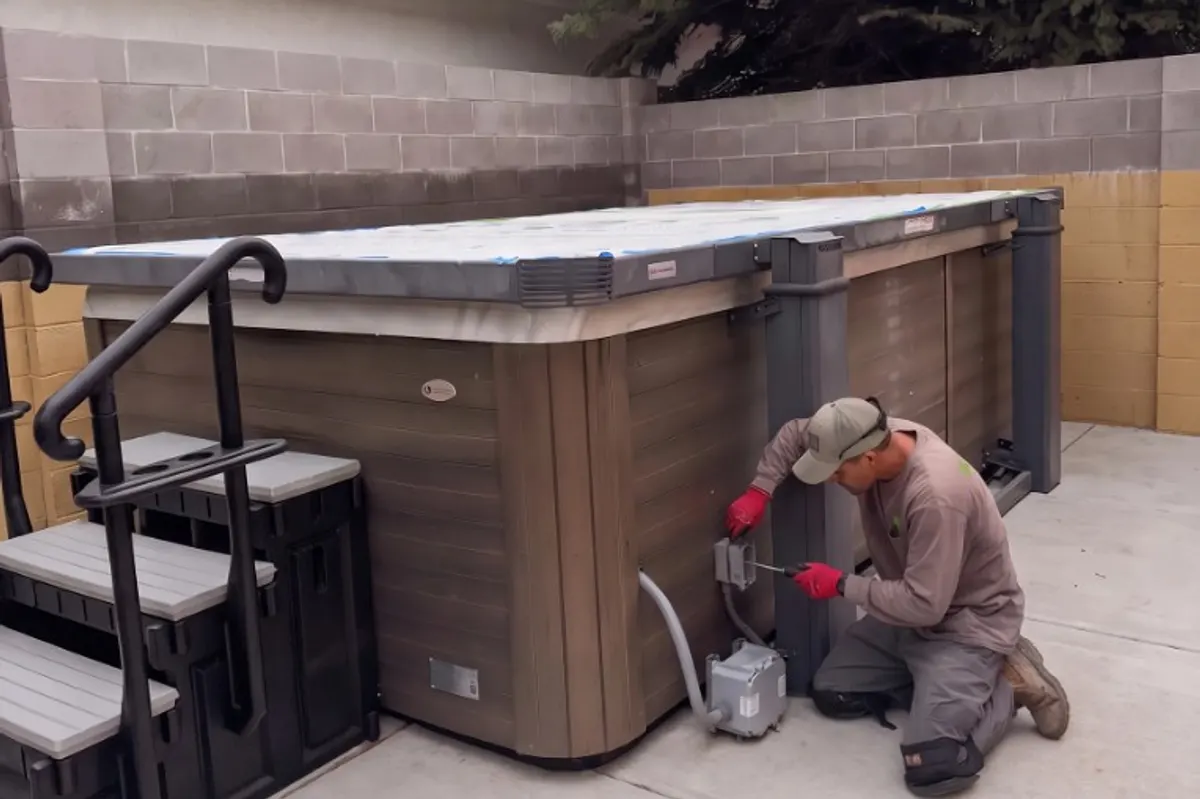 Electrician wiring the disconnect for a hot tub installation